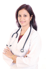 Fototapeta premium Smiling doctor woman with arms crossed against white background
