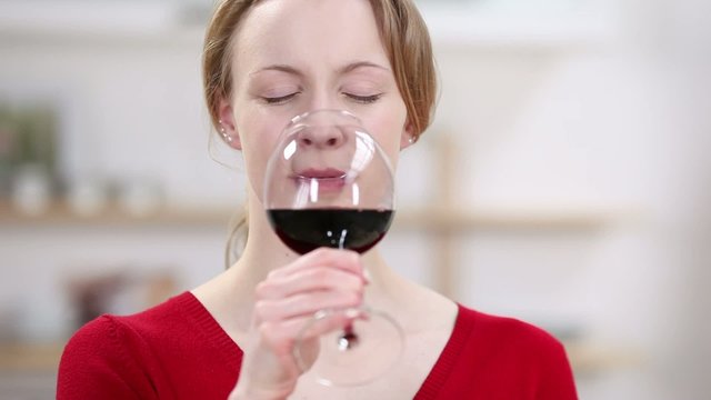 blonde frau genießt ein glas rotwein