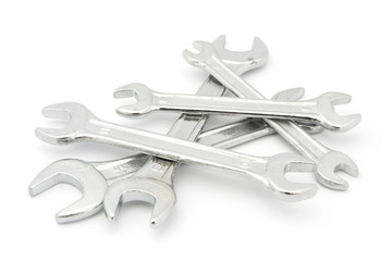 Pile of spanners over white