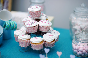 Delicious colorful wedding cupcakes with hearts icing