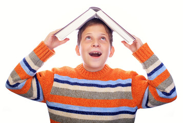 Student child with a book on his head isolated over white
