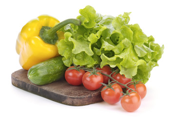 cherry tomatoes, salad and paprika on cutting board isolated on