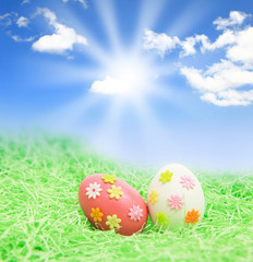 Easter eggs on grass with blue sky