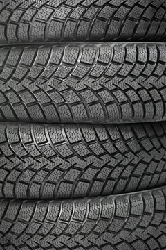 Background of four car wheel winter tires