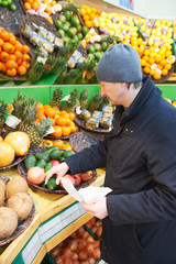 man choosing vegetables in supermarket store