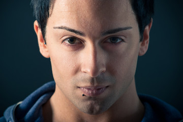 Fototapeta premium Close up portrait of confident man on dark background.