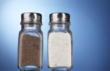 Salt and pepper mills on blue