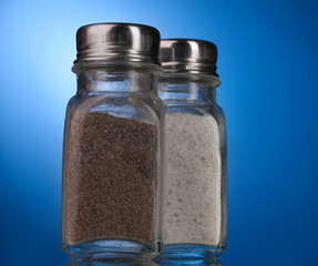 Salt and pepper mills on blue