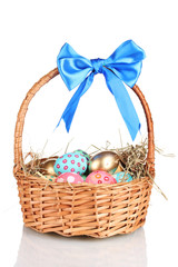 Fototapeta na wymiar Colorful Easter eggs in the basket with a blue bow isolated