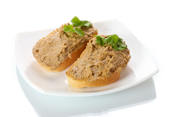 Fresh pate on bread on white plate isolated on white