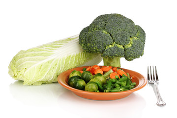 Mixed vegetables on plate isolated on white