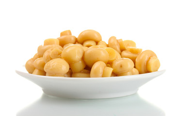 Marinated mushrooms in white saucer isolated on white