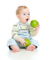 Fototapeta premium Baby boy eating healthy food isolated