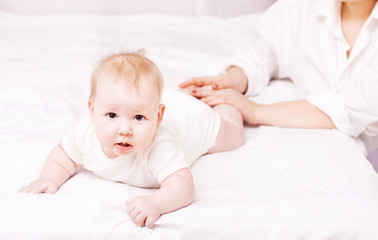 Mother massaging and exercise her little baby