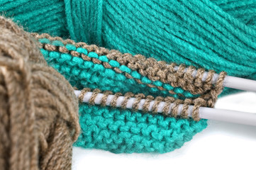 Woollen thread and knitting needle.