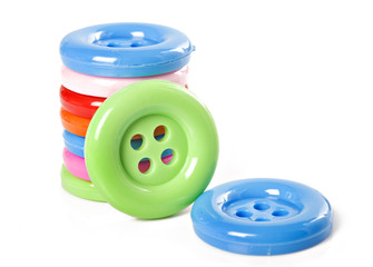 Colorful buttons stacked up on white background.