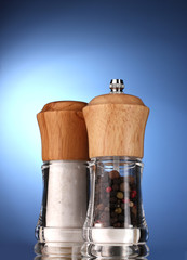 Salt and pepper mills on blue