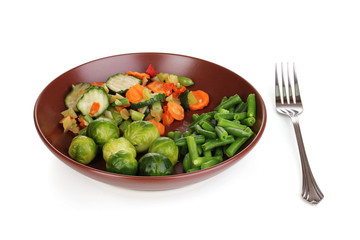 Mixed vegetables on plate isolated on white