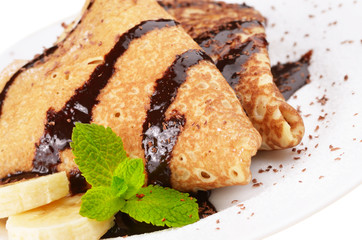 Crepes with banana and chocolate syrup