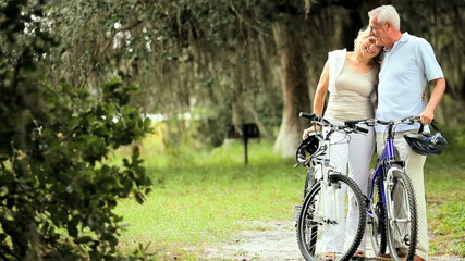 Active Mature Couple Cycling for Exercise