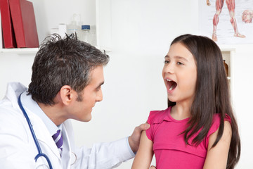Doctor Examining a Child Mouth
