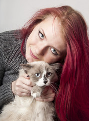 Fototapeta na wymiar Young girl with a cat