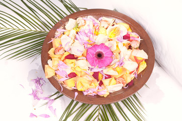 Fototapeta na wymiar Wooden bowl with petals
