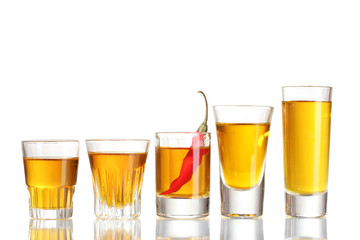 glasses of pepper vodka and red chili pepper isolated on white