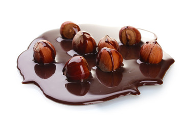 delicious hazelnut and chocolate syrup isolated on white