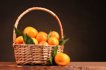 tangerines with leaves in a beautiful basket