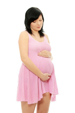 Pregnant woman portrait holding her belly