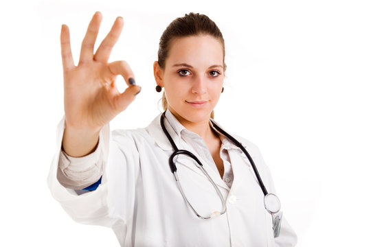 Happy smiling female doctor with okay gesture, isolated on white