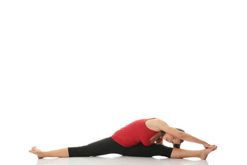 Fototapeta na wymiar Young woman doing stretching exercise