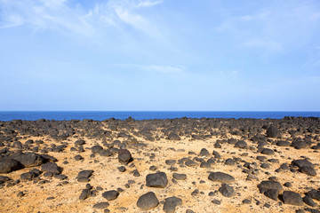 dry area with old lava stones  at the coastline