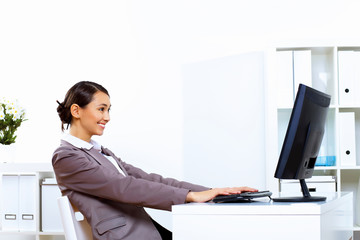 Young woman in business wear working in office