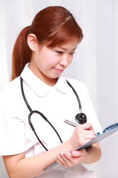 young japanese nurse with medical chart