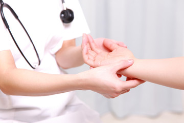 nurse measuring patient's pulse