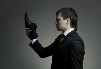 Surreal portrait of a stylish man in an elegant suit and shoes i