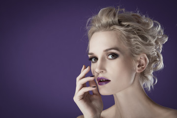 The image of a beautiful luxurious woman on purple background. S