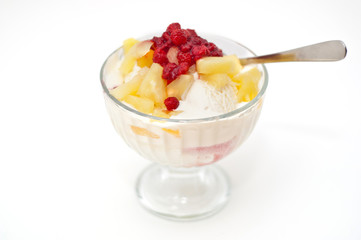 ice cream with fresh berries and pineapple on top on white