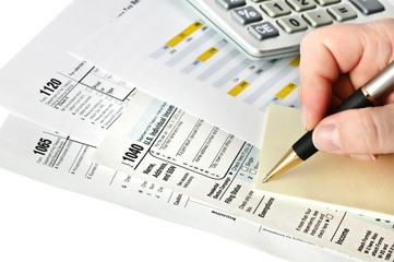 Financial forms with pen, calculator and sticker. Isolated.