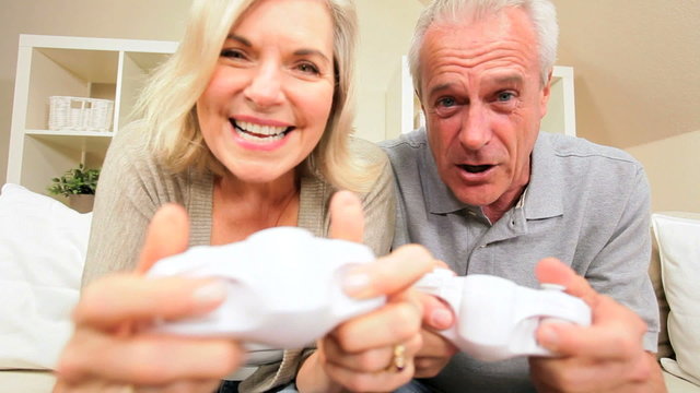 Attractive Older Couple Playing Wireless Electronic Games