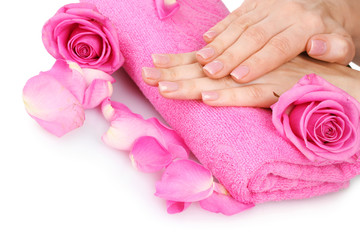 Pink towel with roses and hands on white background