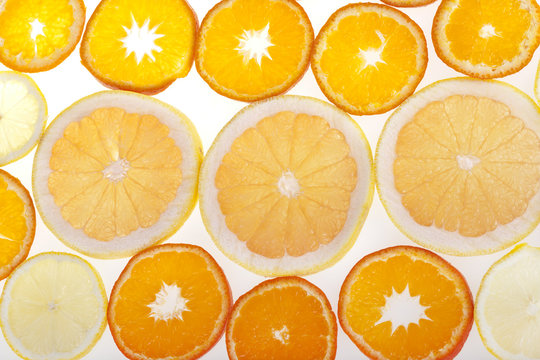 Fresh slices of citrus fruits in studio backlight