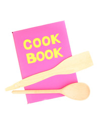 Pink cookbook and kitchenware isolated on white