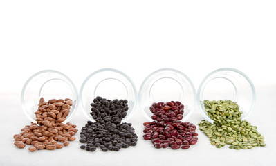 Beans and split peas spilling out of glass jars