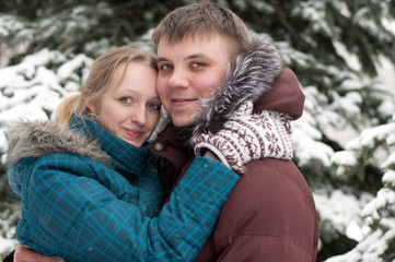 Fototapeta premium Young lovers woman and man in a winter forest