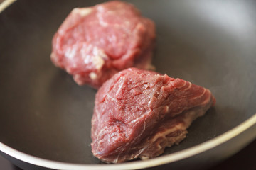 beef steak in a frying pan