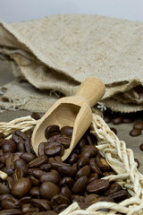 Fresh coffee beans in a basket with wooden scoop