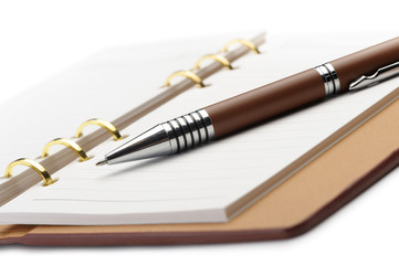 Open notebook with copper binding and stylish pen